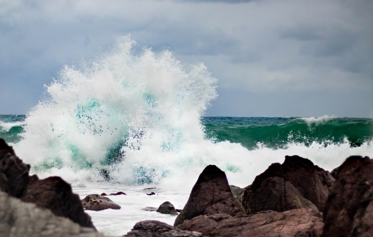 Surf breaking on the Red Rocks on Wellington's south coast